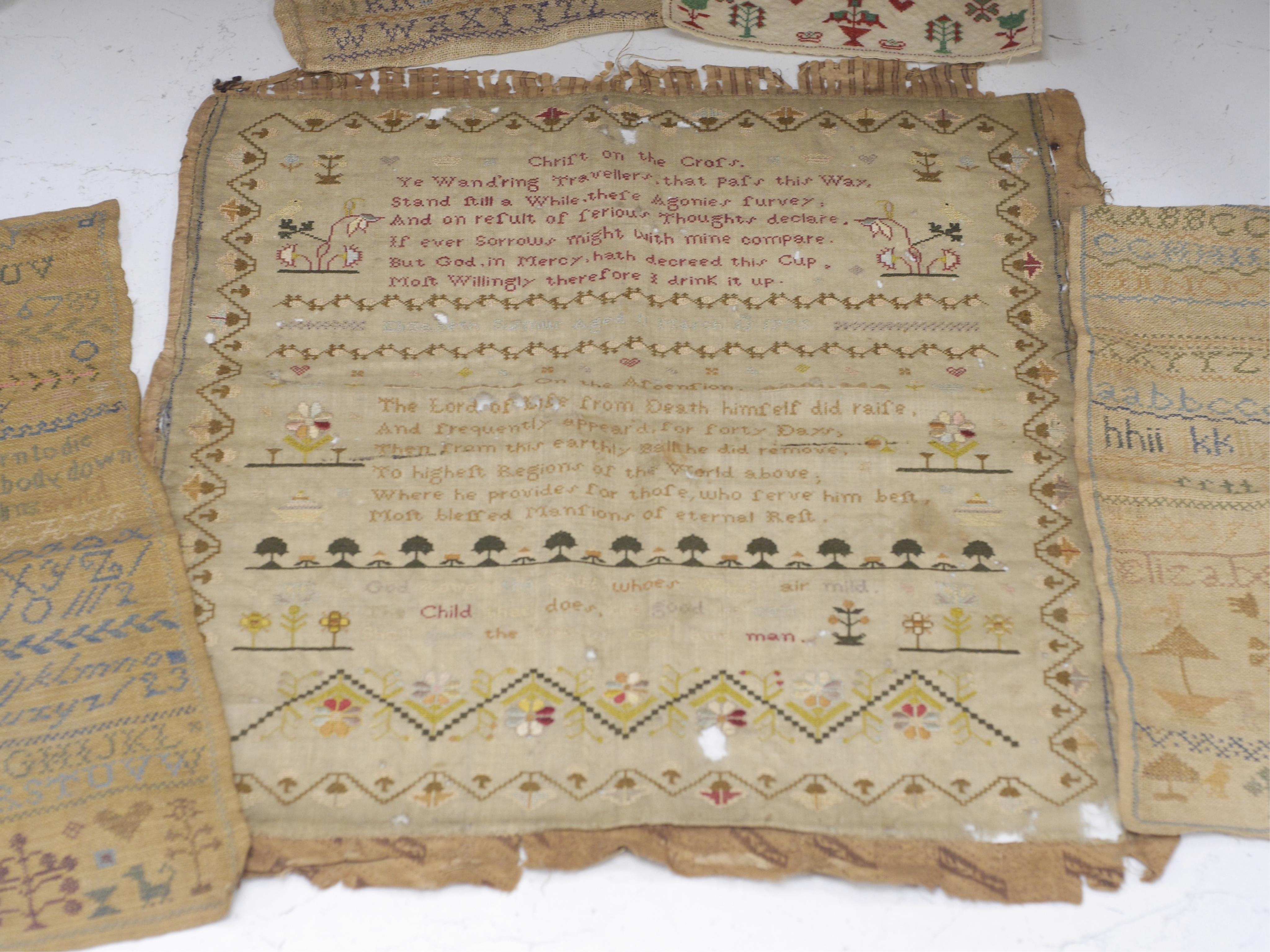 A collection of four 19th century cross stitch alphabet samplers and a larger earlier sampler embroidered by Elizabeth Sizmur aged 11 dated 1795, designed with spot motifs and religious verse. 18th century sampler 42cm x